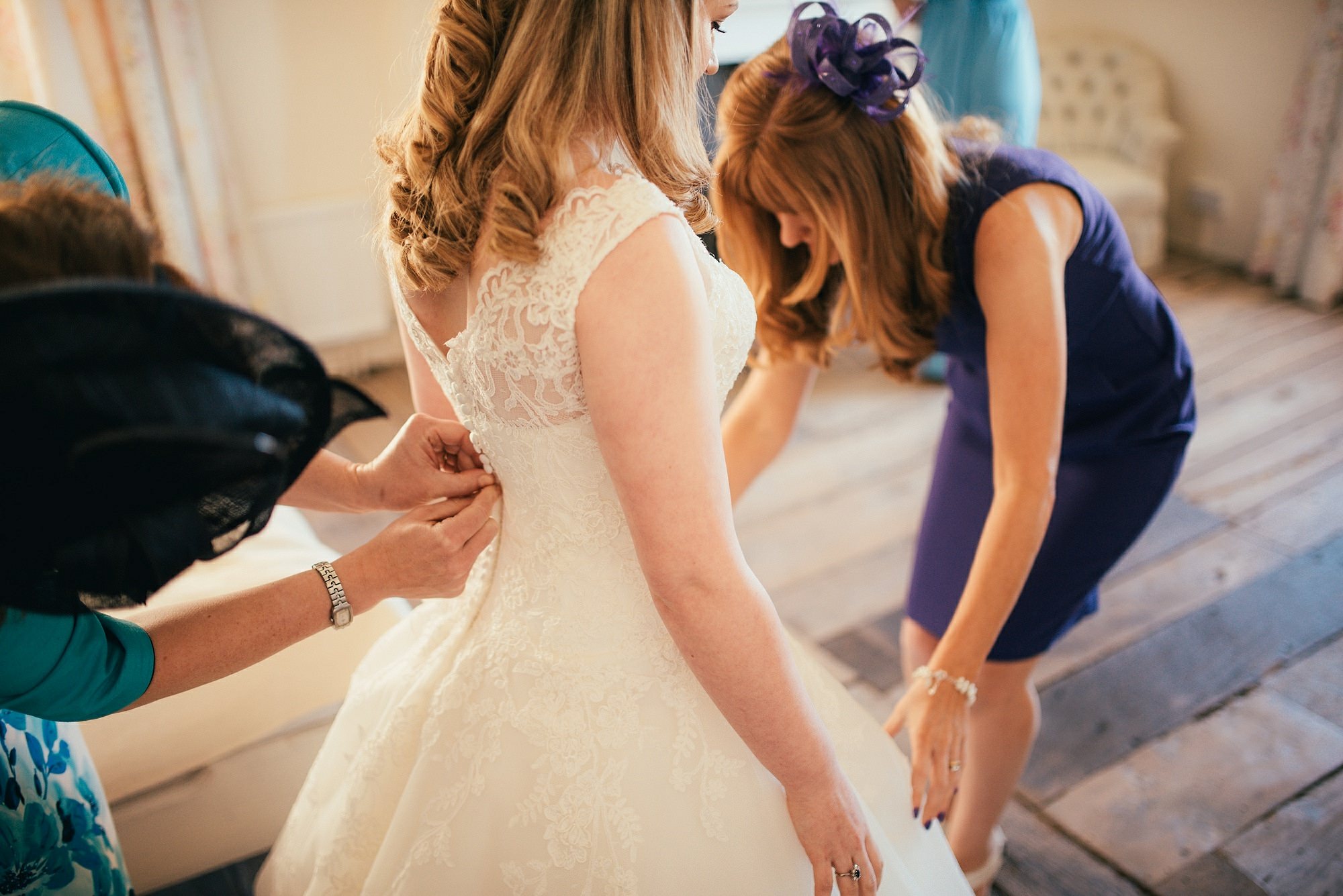 bride having dress done up
