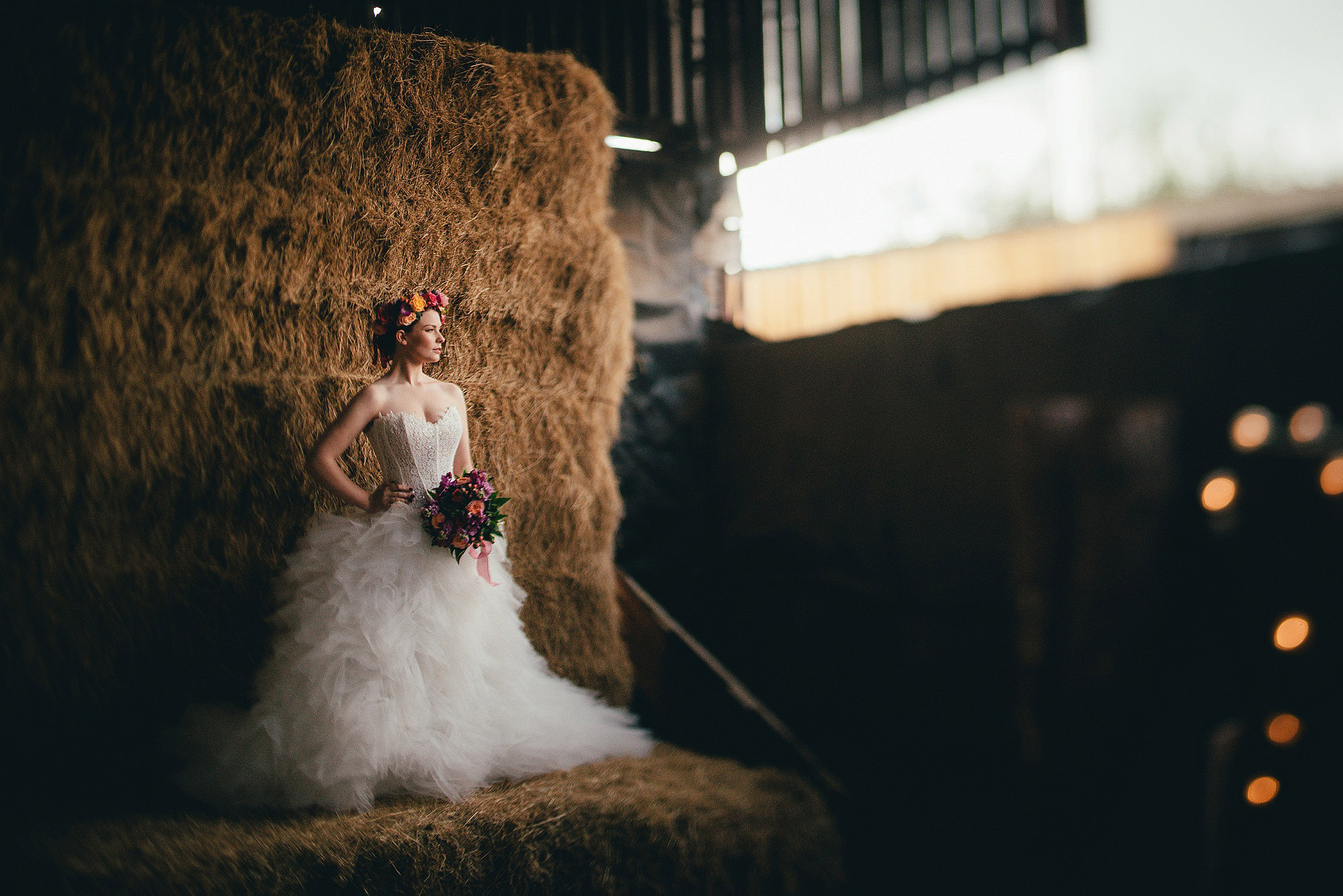 Bride on hay stack at Bride at Owens House Barn Kuntsford