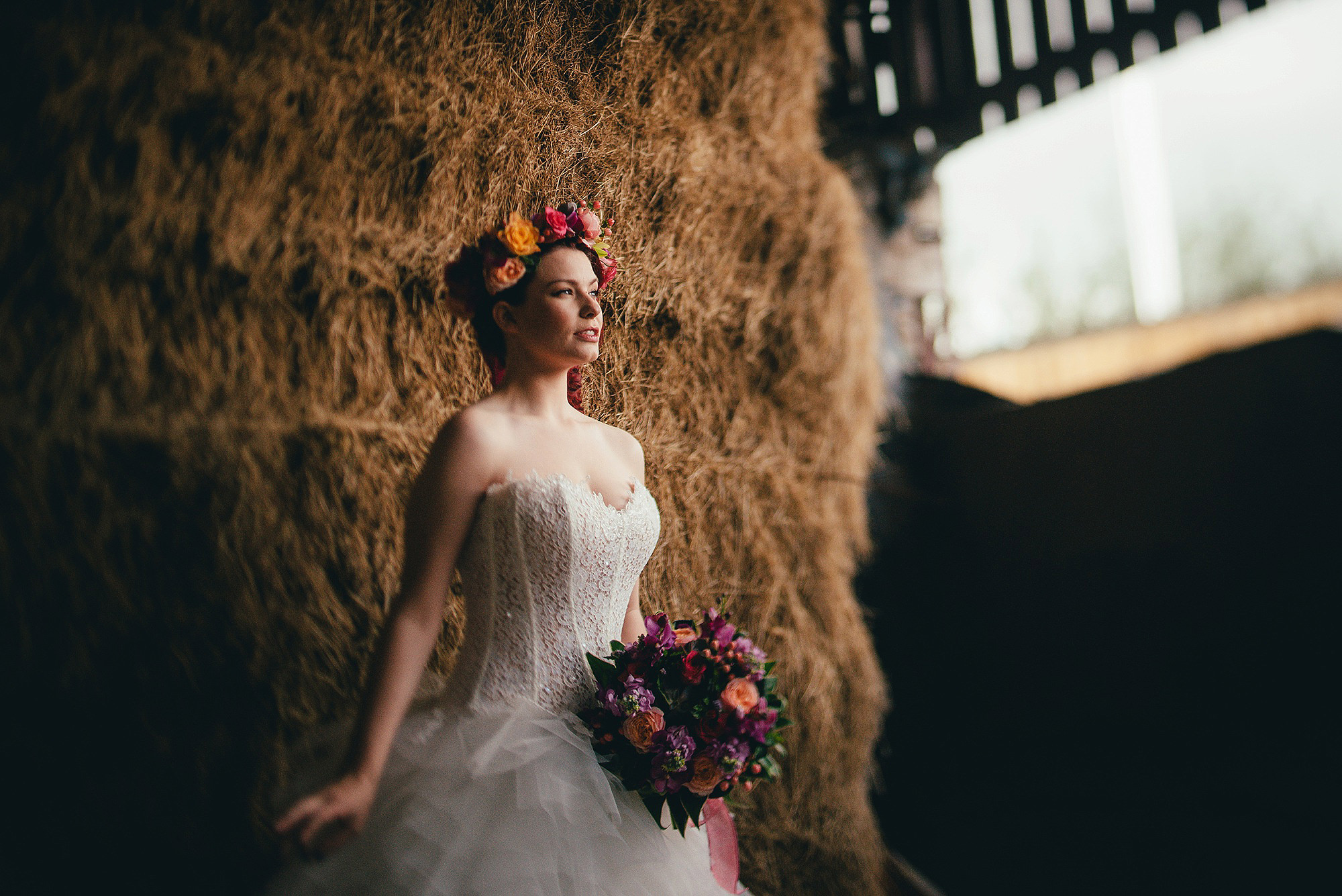 Bride on hay stack at Bride at Owens House Barn Kuntsford