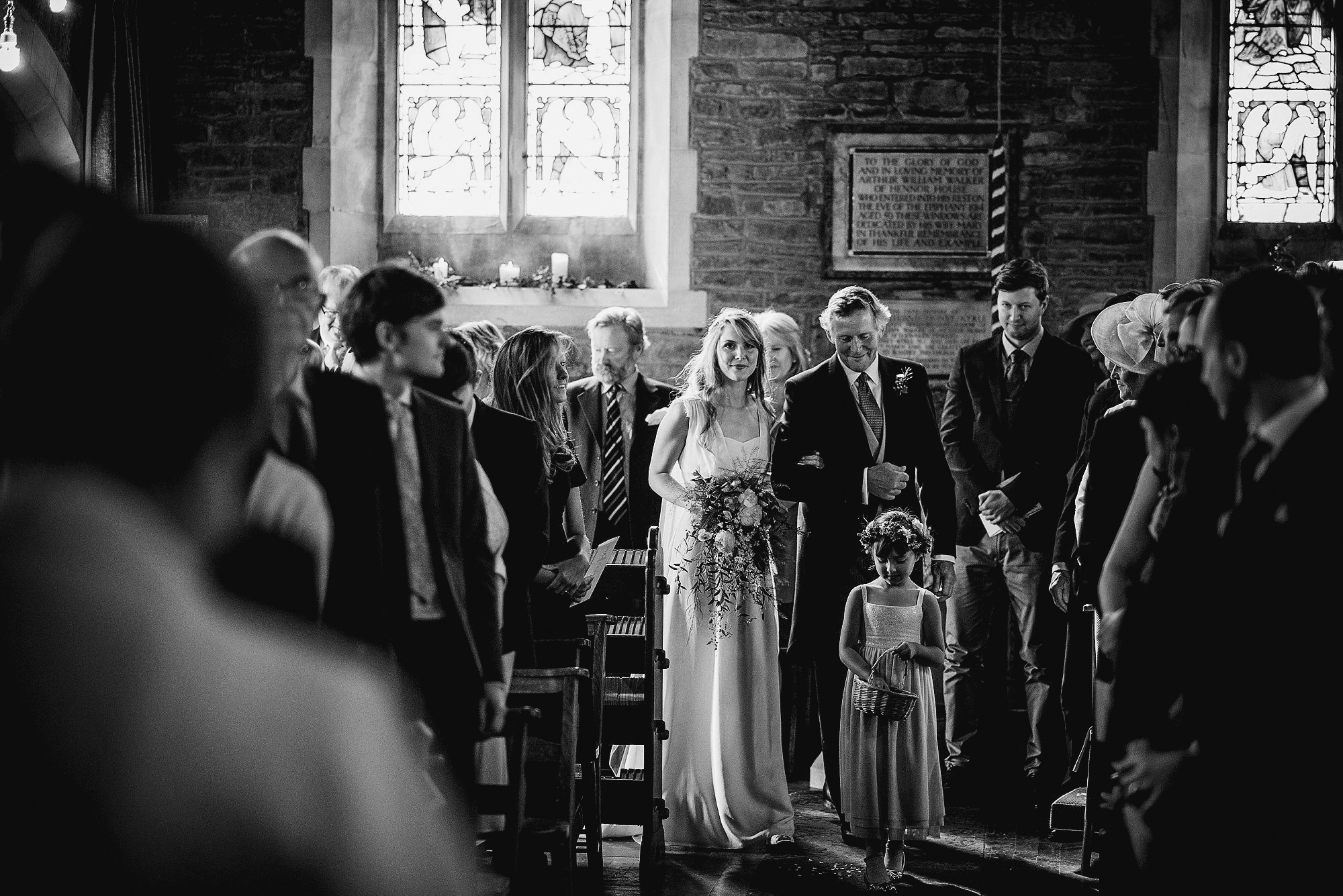 bride and dad walking down aisle with flower girl